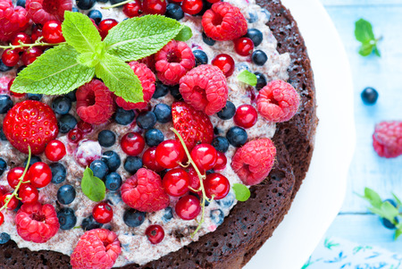 Summer cake with fresh berries. Chocolate cake. Biscuit.