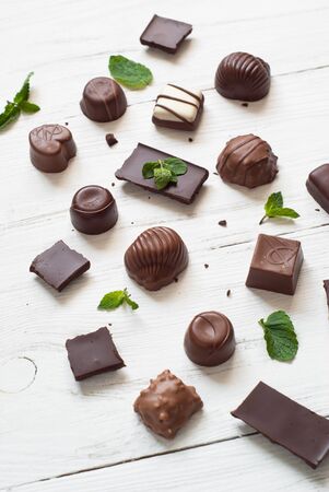 Different chocolate candies on a white background. Top view.の写真素材