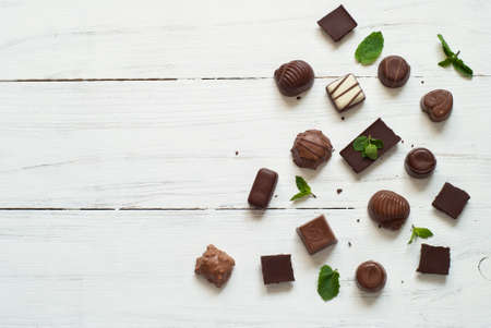 Different chocolate candies on a white background. Top view.の写真素材