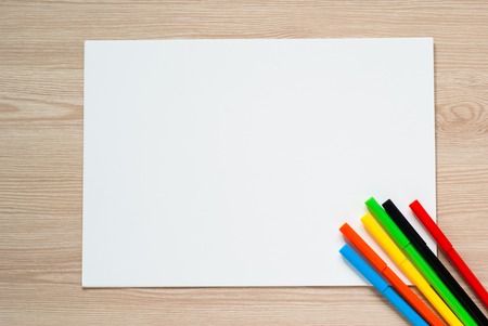 Pencils, crayons and album sheet on a desk. Top view with copy space.の写真素材