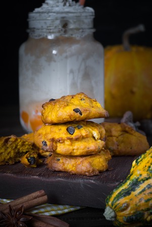 Pumpkin layered latte with whipped cream and pumpkin cookies. American fall food.の写真素材