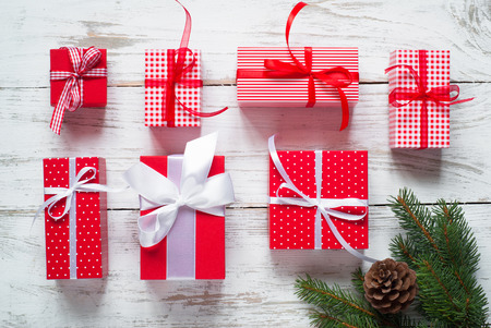 Christmas gift box. Different Christmas presents in red boxes. Flat lay.