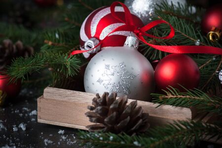 Christmas Festive background. Christmas decorations silver and red bauble in the box. Greeting card.の写真素材