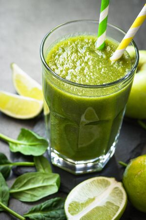 Healthy green spinach smoothie in glassの写真素材