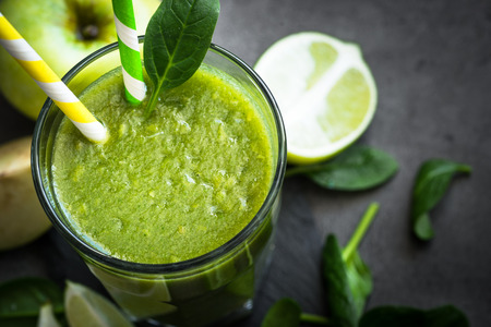 Healthy green spinach smoothie in glassの写真素材