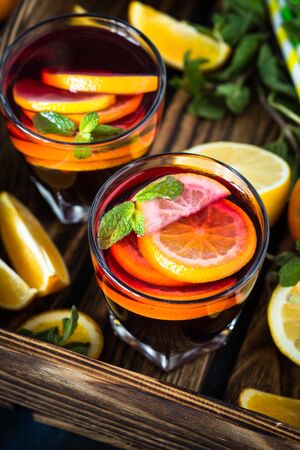 Sangria with fruit mint and ice in wooden tray. Traditional alcoholic cocktail. Summer drink.の写真素材