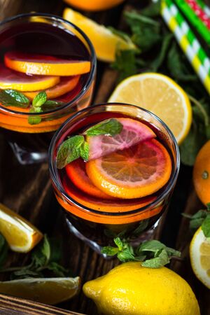 Sangria with fruit mint and ice in wooden tray. Traditional alcoholic cocktail. Summer drink.の写真素材