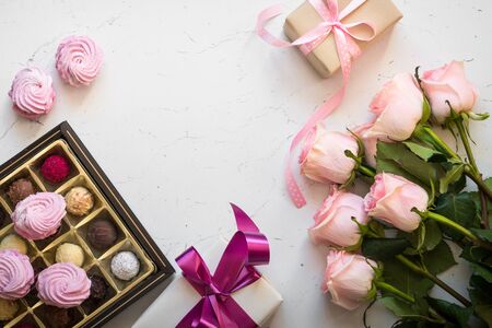 Pink rose present and truffle at white table. Top view copy space. Mothers day background. Greeting card.の写真素材