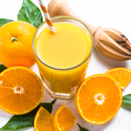 Orange juice in glass on white.の写真素材