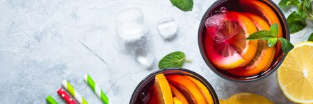 Sangria with fruit mint and ice. Traditional alcoholic cocktail. Summer drink. Long banner format.の写真素材