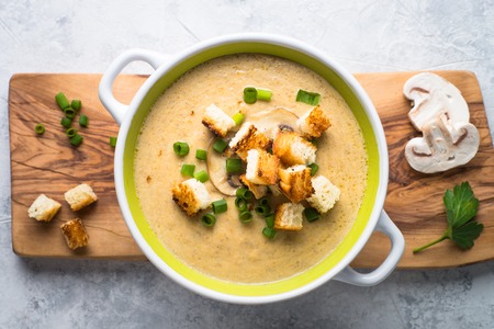 Creamy Mushroom Soup with croutons on gray  concrete table. European cuisine.の写真素材