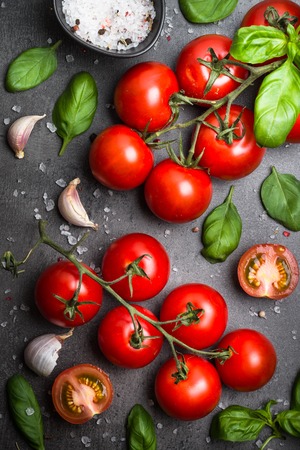 Fresh tomatoes on black slate background.の写真素材