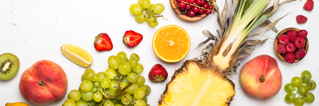 Tropical Fruit and berries on white table.  Pineapple, grapes, citrus and berry mix.の写真素材
