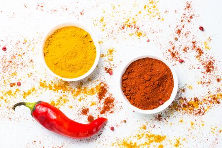 Ground pepper, turmeric and fresh chili pepper on white background. Top view.の写真素材