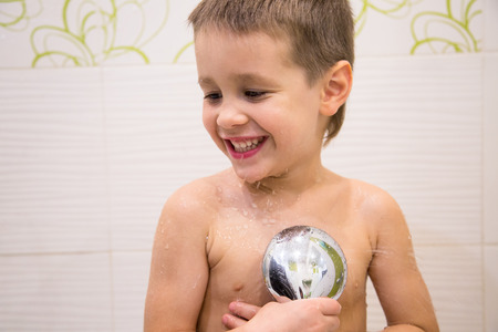 Charming child bathing in the bathroomの写真素材