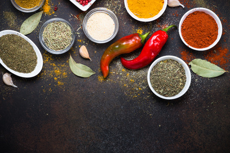 Various spices on rusty stone table. Top view with copy space.の写真素材