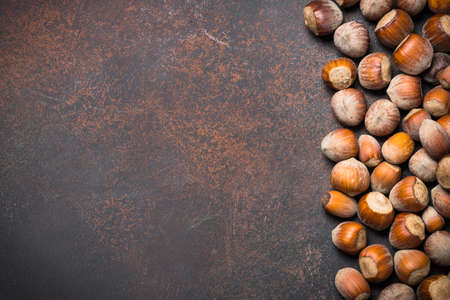 Fresh forest hazelnut on dark rusty stone or metal background. Top view copy space.の写真素材