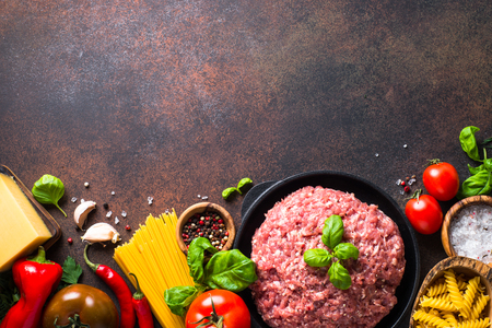 Minced meat, pasta and vegetables. Ingredients for cooking spaghetti bolognese. Top view.の写真素材