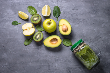 Healthy green smoothie in mason jar and ingredients.の写真素材