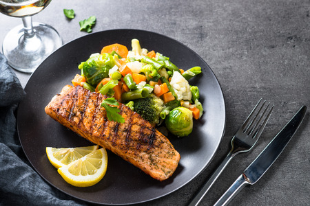 Grilled salmon fillet with vegetables mix.の写真素材