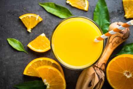 Orange juice in glass on black.の写真素材