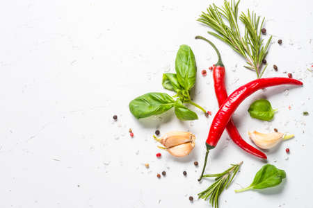 Spices and herbs over white stone table top view.の写真素材