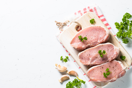 Pork meat steak, slices pork loin on white.の写真素材