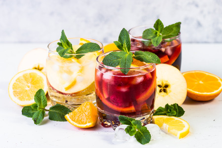 White, pink and red sangria with fruit, ice and mint.の写真素材