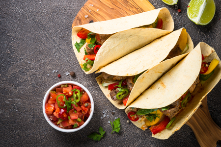 Mexican pork tacos with vegetables and salsa.の写真素材