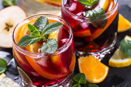 Sangria with fruit, ice and mint in glass.の写真素材