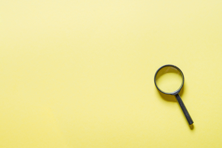 Loupe or magnifier on yellow background.の写真素材