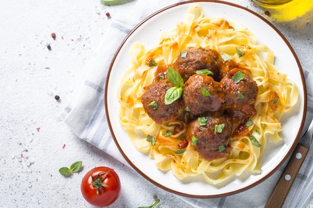 Meatballs in tomato sauce with pasta tagliatelle top view.の写真素材