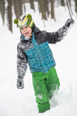 child boy playing in the snow in winter.の写真素材