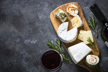 Cheese platter on dark stone table.の写真素材
