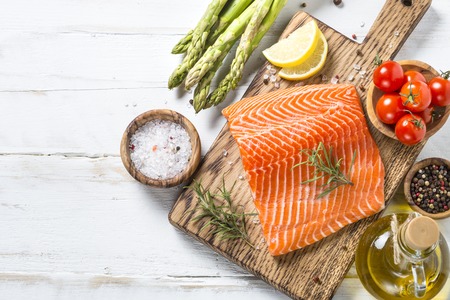 Salmon fillet with ingredients for cooking -  fresh vegetables aの写真素材