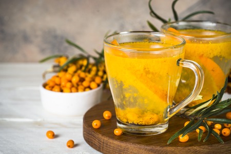 Sea buckthorn tea with orange in a glass cups.の写真素材