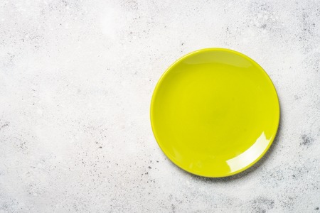 Green plate on light stone table.の写真素材