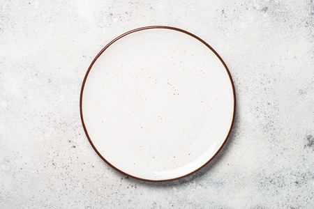 White craft plate on white stone table top view.の写真素材