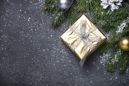 Gold present box and decorations on black stoneの写真素材