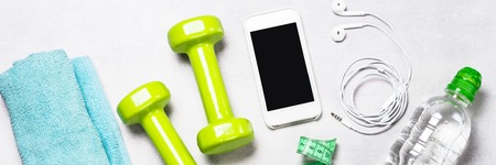 Dumbbells, measuring tape, water and apple top view.の写真素材