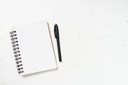 Notepad and pen on white.の写真素材