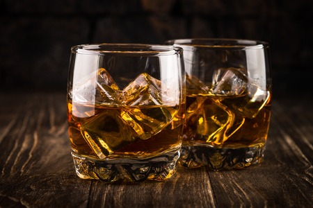 Whiskey in the glasses on dark background.の写真素材