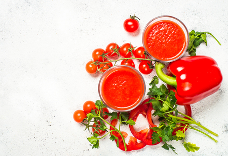 Tomato vegetable juice in glass on white.の写真素材