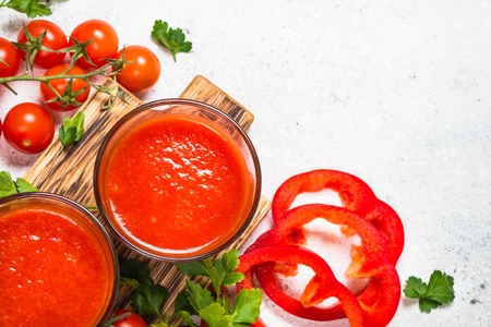 Tomato vegetable juice in glass on white.の写真素材