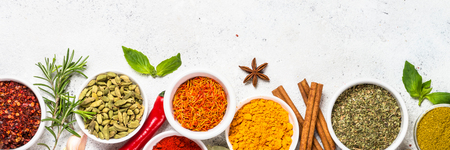 Spices and herbs on white stone table.の写真素材