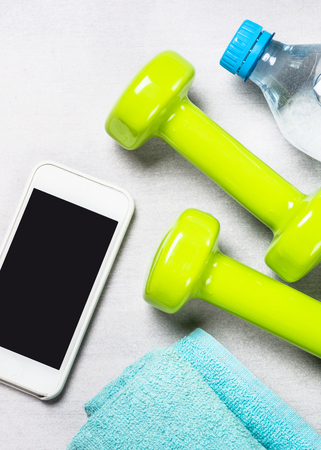 Dumbbells, measuring tape, water and apple top view.の写真素材