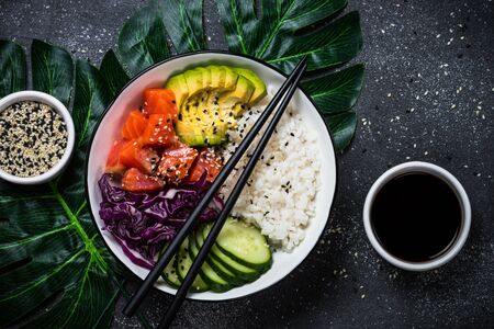 Poke bowl on black top view.の写真素材
