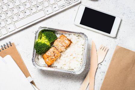 Food delivery concept - healthy lunch on office table.の写真素材