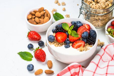 Greek yogurt granola with fresh berries on white table.の写真素材