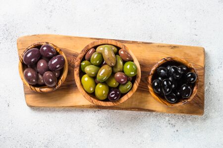 Black and green olives on white background.の写真素材
